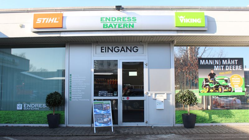 Der Eingang eines Gartencenters mit Werbeschildern von STIHL und VIKING.