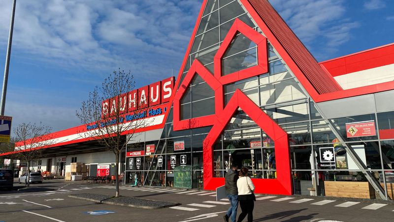 Der Eingang eines Bauhaus-Baumarkts mit markanter roter Architektur und Glasfassade.