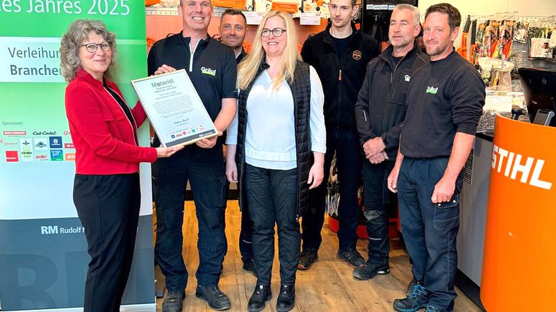Eine Gruppe von Menschen bei der Preisverleihung "Motorist des Jahres 2025" in einem Geschäft mit STIHL-Produkten.