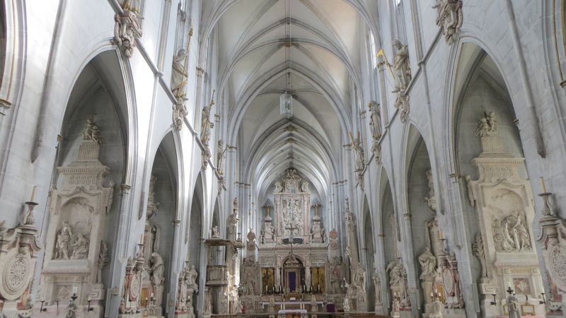 Innenansicht einer gotischen Kathedrale mit hohen Gewölbedecken und kunstvollen Verzierungen.