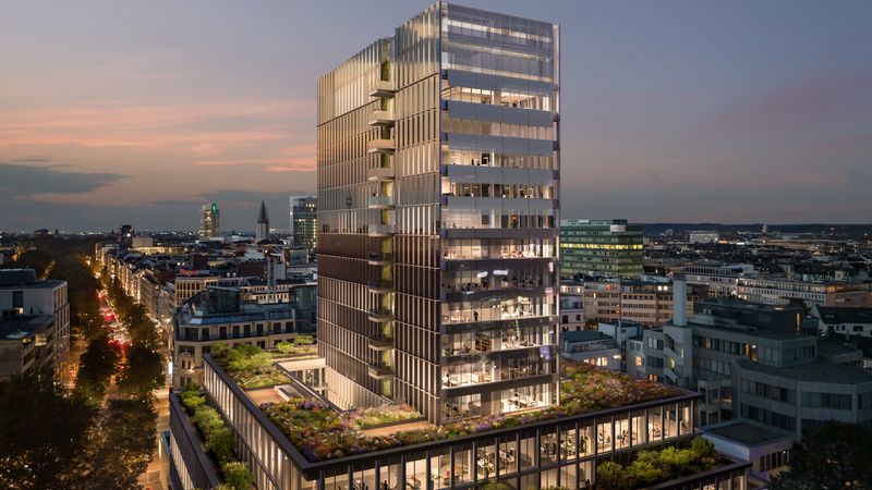 Ein moderner Büroturm in der Abenddämmerung, umgeben von einer urbanen Skyline mit beleuchteten Straßen und Gebäuden.