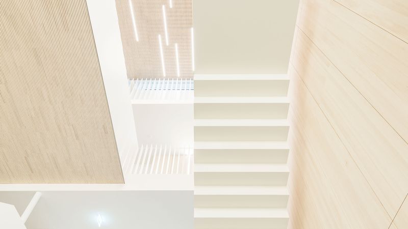 Besonderes Entwurfshighlight im EWS-Neubau ist die große dreigeschossige Treppenhalle. Damit bei einer Raumhöhe von etwa 11 Metern keine Hallgeräusche entstehen, wurden die eingesetzten Dachbauteile ab Werk akustisch wirksam konfiguriert. Foto: Lignotrend / Foto: Olaf Herzog, Waldkirch