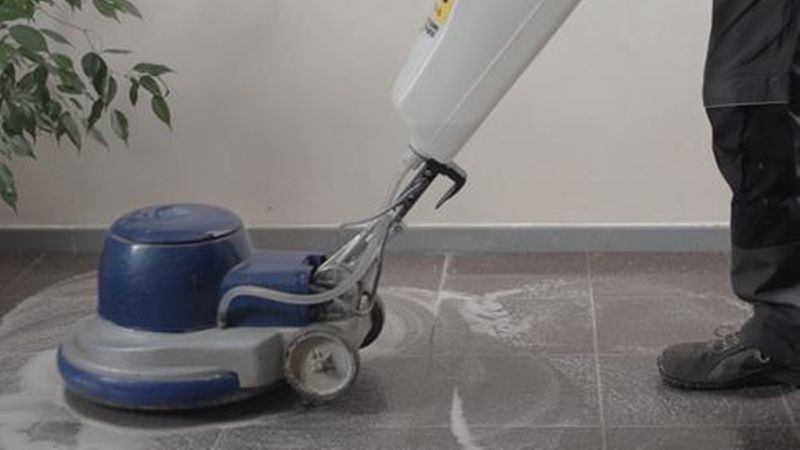 Die Bodenfliesen reinigen: erst grobe Verschmutzungen wegkehren oder wegsaugen, dann den Zementschleier mit dem passenden Spezialreiniger entfernen.